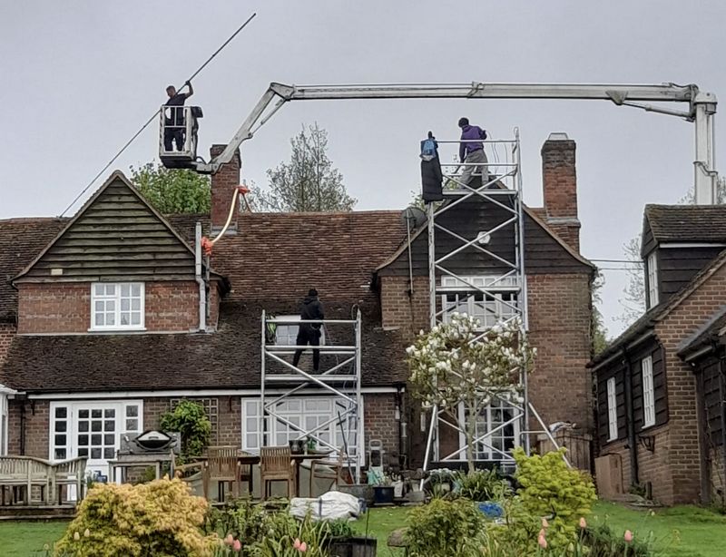 The Roof Moss Cleaners using cherry picker and scaffolding to clean roof safely and professionally in Oaklands, Hertfordshire
